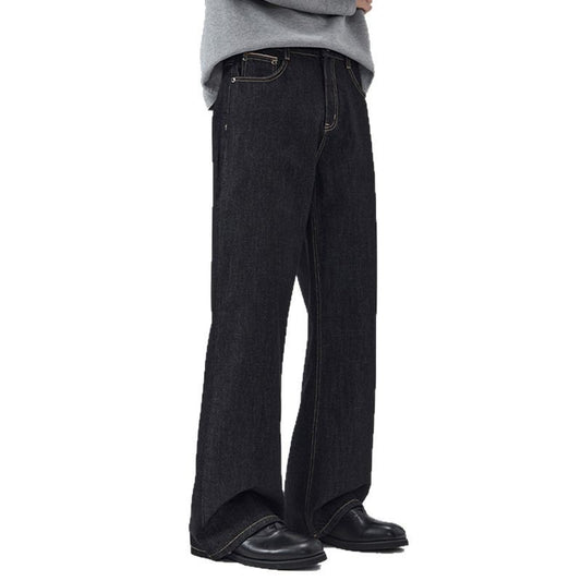 Person wearing black wide-leg jeans on a white background
