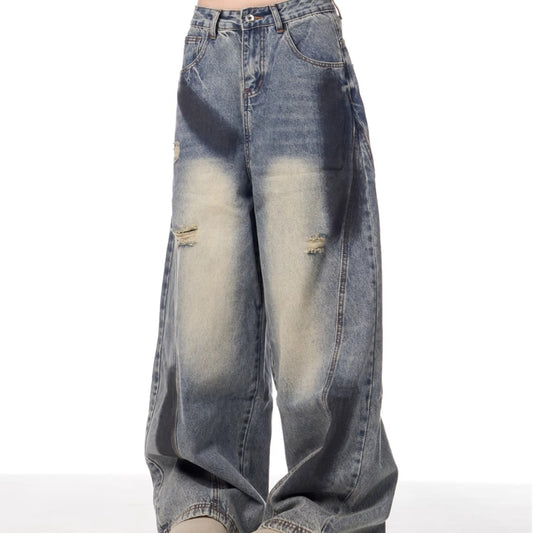 Distressed blue jeans on a white background